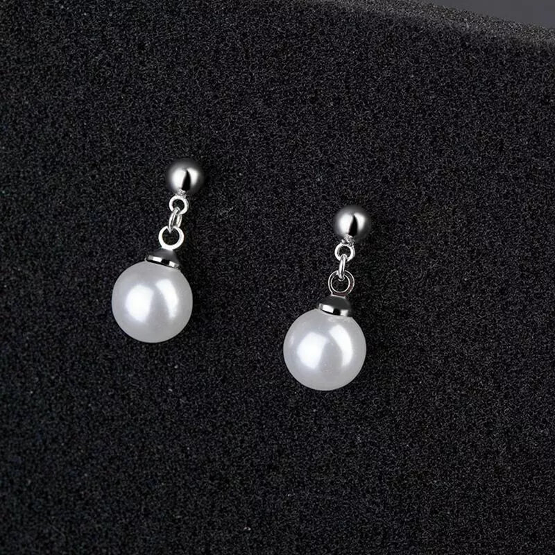 Close-up of pearl drop stud earrings