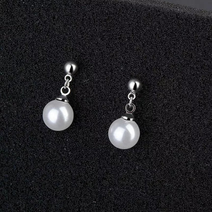 Close-up of pearl drop stud earrings