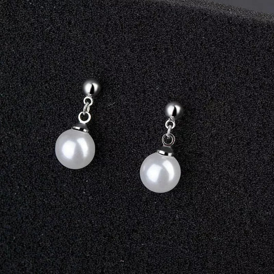 Close-up of pearl drop stud earrings